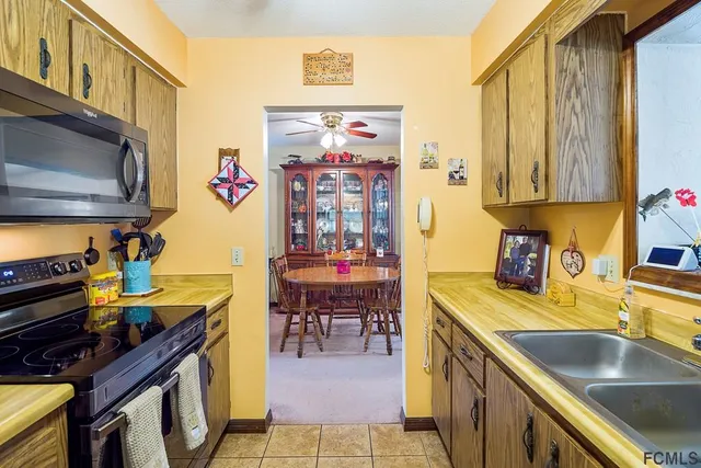 a kitchen with stainless steel appliances a stove a sink and a microwave