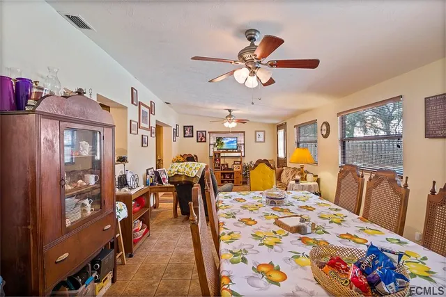 a bedroom with a bed a chandelier and dresser