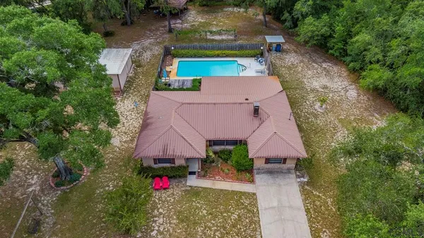 an aerial view of house with yard swimming pool and outdoor seating