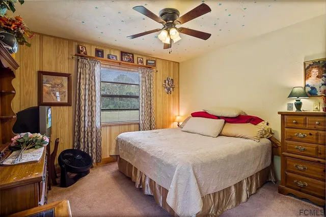 a bedroom with a bed and a large mirror with a potted plant