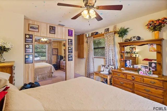 a view of a house with a swimming pool and a chairs