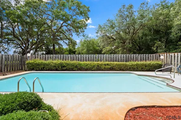 a view of backyard with outdoor seating and green space