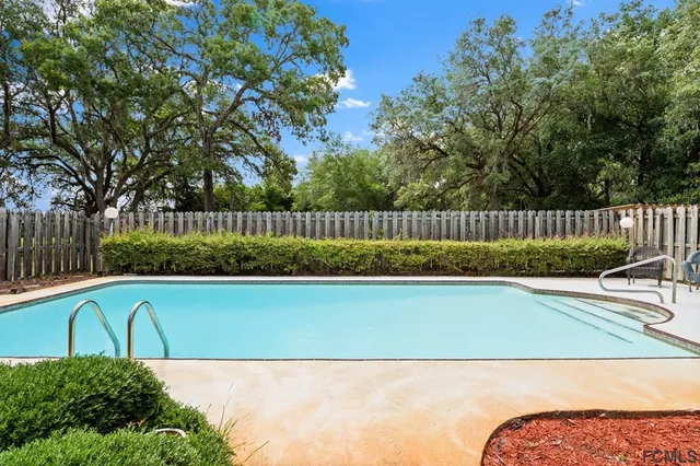 a view of backyard with outdoor seating and green space
