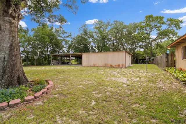 a backyard of a house with lots of green space and garden