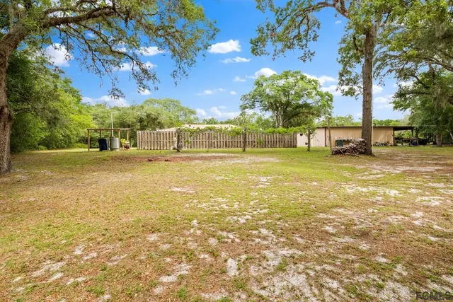 a view of a backyard of the house