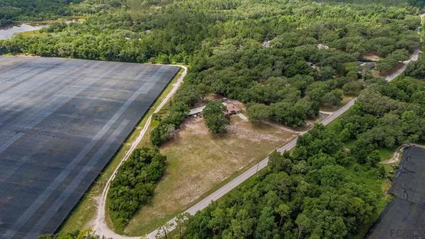 an aerial view of a house with outdoor space and lake view