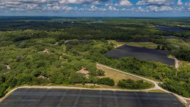 a view of a patio with a table and chairs under an umbrella