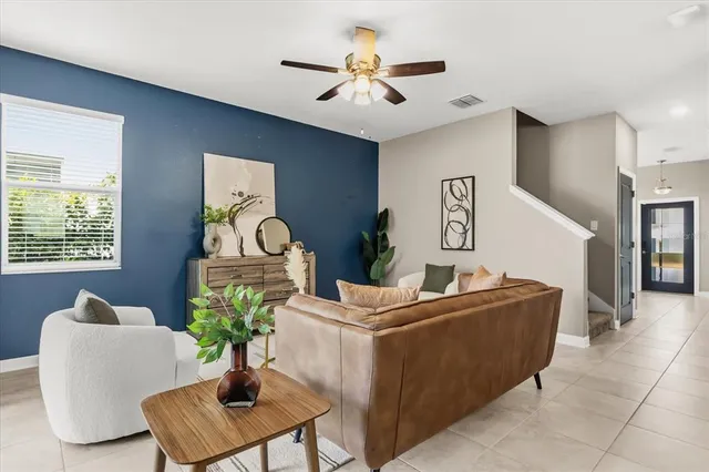 a living room with furniture and a chandelier
