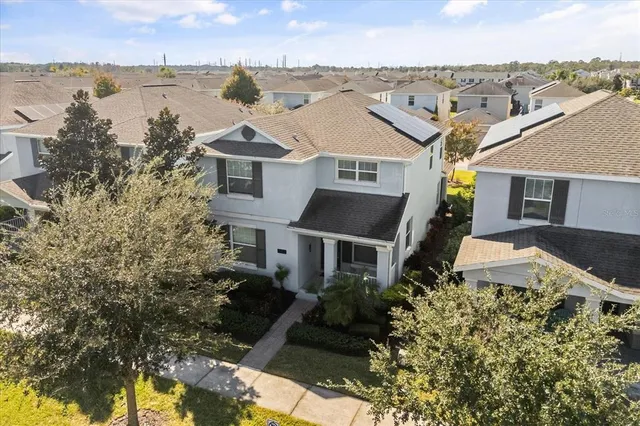 an aerial view of residential houses with yard