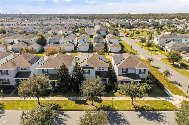 an aerial view of residential houses with outdoor space