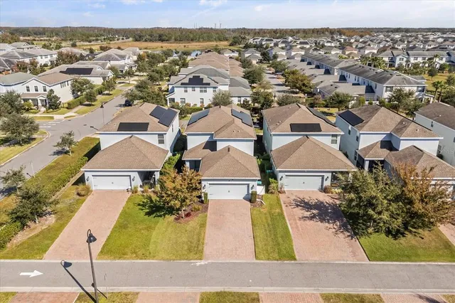 an aerial view of a house with a swimming pool