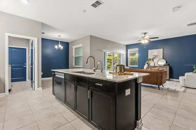 a kitchen with a sink counter and chairs