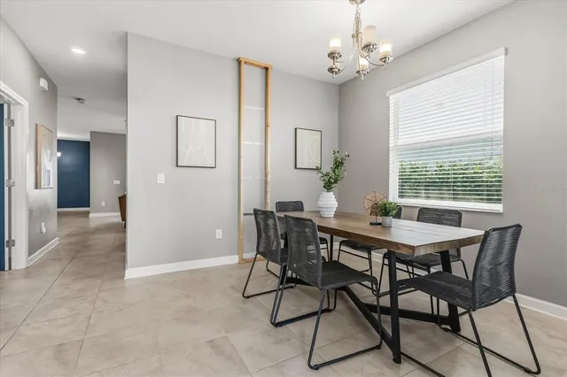 a view of a dining room with furniture and a chandelier