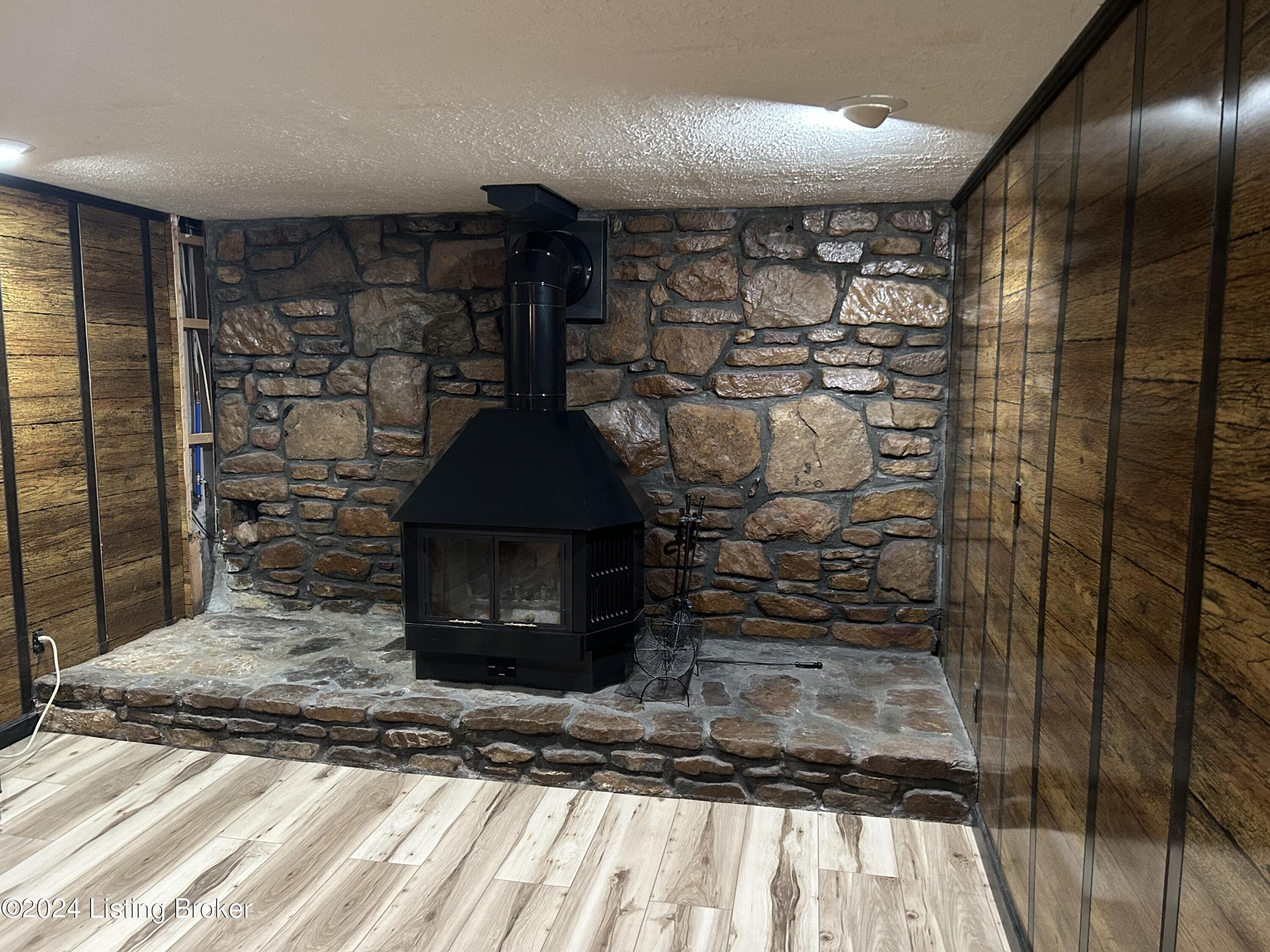 8212 Rochelle Road Louisville, KY 40228 - Photo 18 of 23 fireplace in basement with stone wall