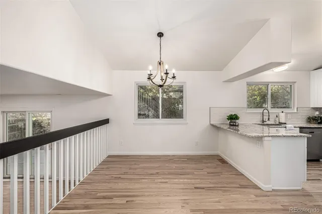 a kitchen with stainless steel appliances granite countertop white cabinets a stove a microwave and a refrigerator