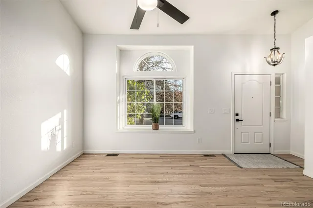 a view of entryway and hall with wooden floor