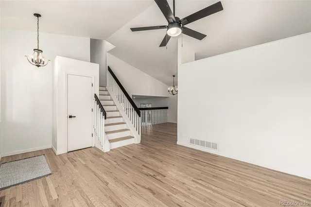 a view of an empty room with wooden floor