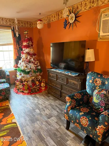 a living room with patio furniture and a rug
