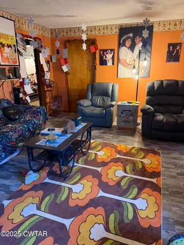 a kitchen with stainless steel appliances granite countertop a sink a stove and a wooden cabinets