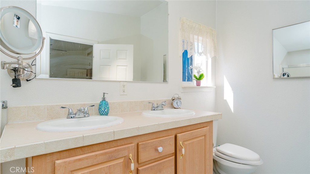 15621 Beach Boulevard Westminster, CA 92683 - Photo 13 of 25 a bathroom with a granite countertop toilet sink and mirror