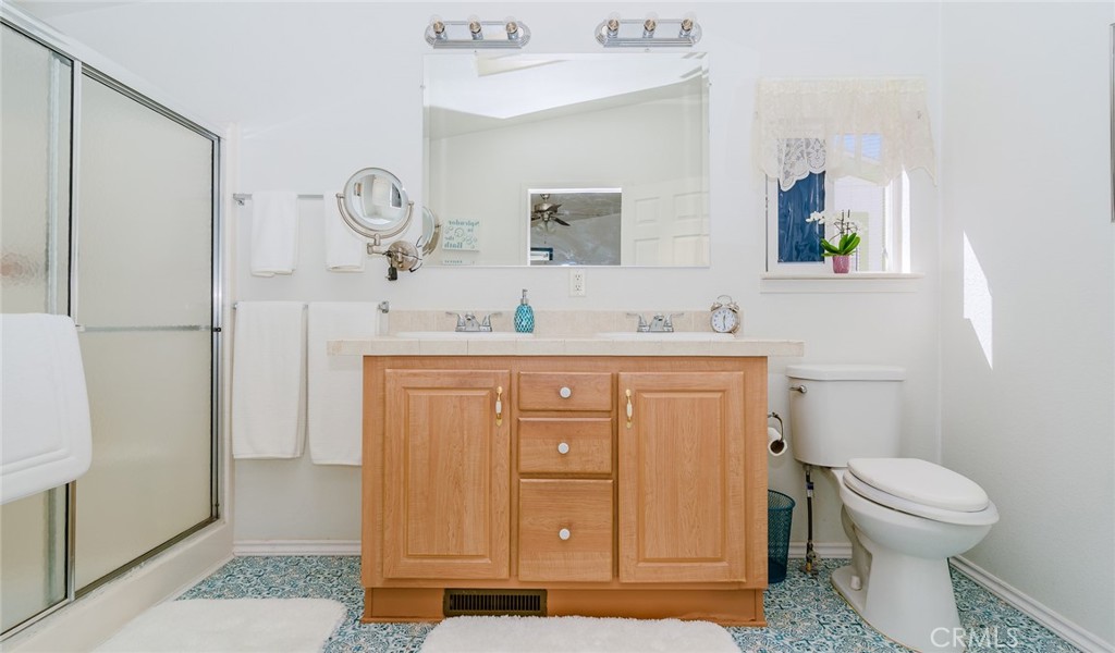 15621 Beach Boulevard Westminster, CA 92683 - Photo 16 of 25 a bathroom with a sink a toilet and a mirror