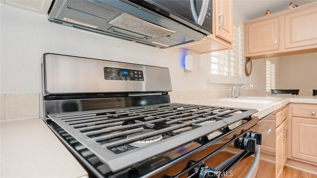 15621 Beach Boulevard Westminster, CA 92683 - Photo 19 of 25 a stove top oven sitting inside of a kitchen