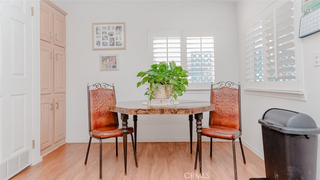 15621 Beach Boulevard Westminster, CA 92683 - Photo 21 of 25 a dining room with furniture and wooden floor