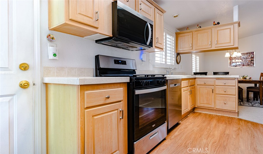 15621 Beach Boulevard Westminster, CA 92683 - Photo 22 of 25 a kitchen with a sink stainless steel appliances and cabinets