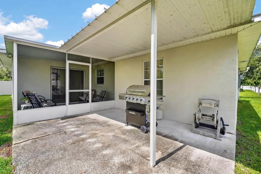 80 Roxboro Drive Palm Coast, FL 32164 - Photo 23 of 39 a porch with a table and chairs