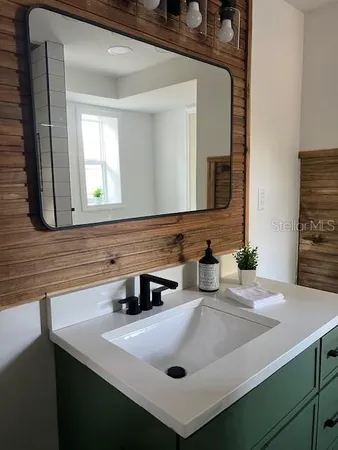 a bathroom with a sink and a mirror