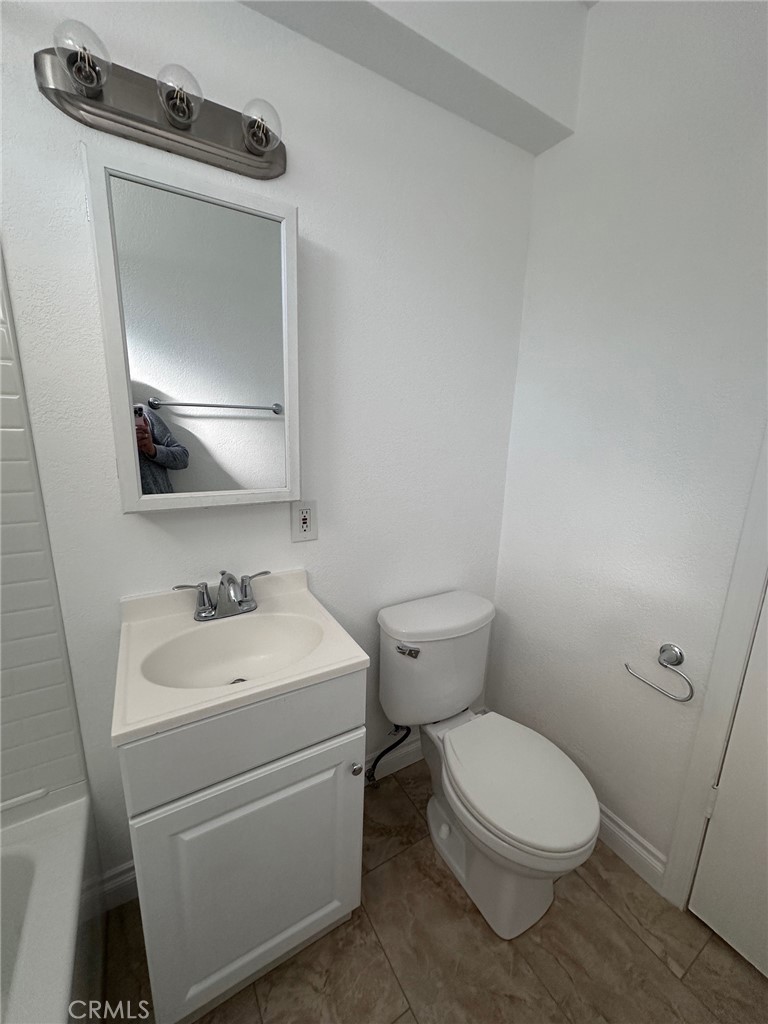 318 East Walnut Street, Unit B Santa Ana, CA 92701 - Photo 7 of 9 a bathroom with a toilet sink and mirror