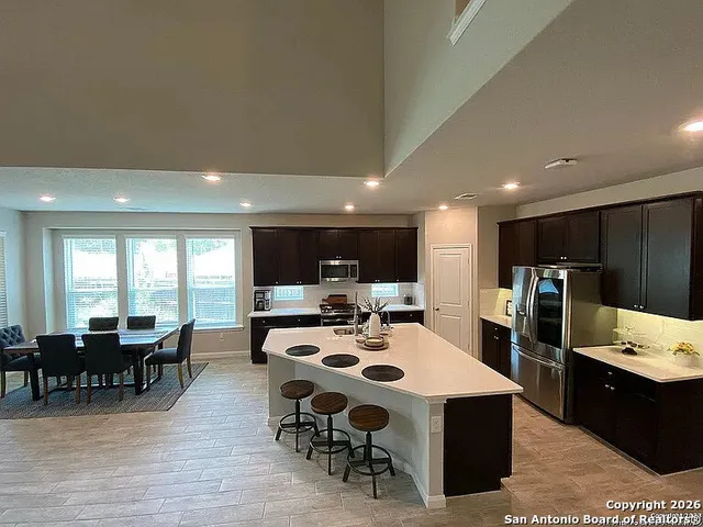 a large kitchen with a table and chairs
