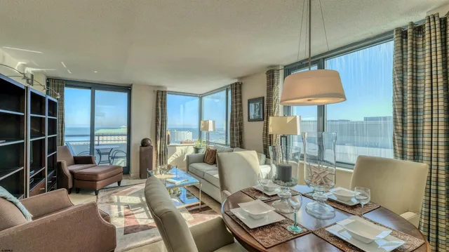 a living room with furniture and a chandelier