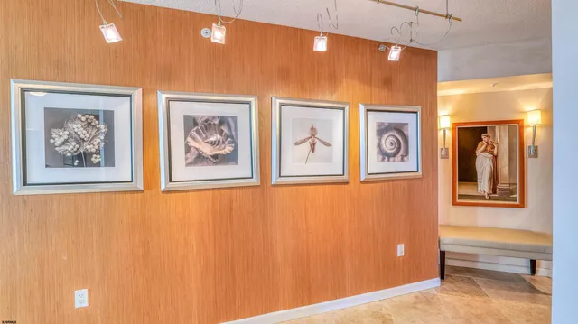 a view of a hallway with paintings on the wall