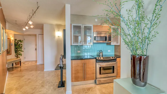 a kitchen with stainless steel appliances granite countertop a sink and a stove