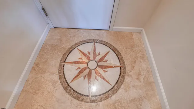 a vase of flowers sitting on a floor in front of a door