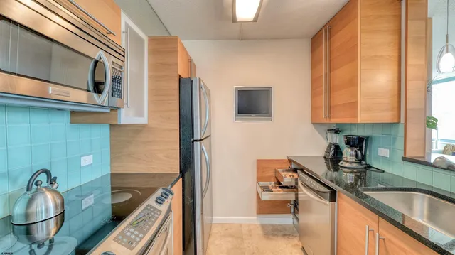 a kitchen with a sink cabinets and a window