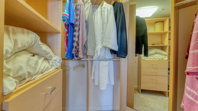 a bedroom with a bed and a mirror on dresser