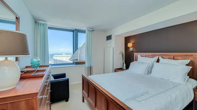 a view of a room with wooden floor and a window