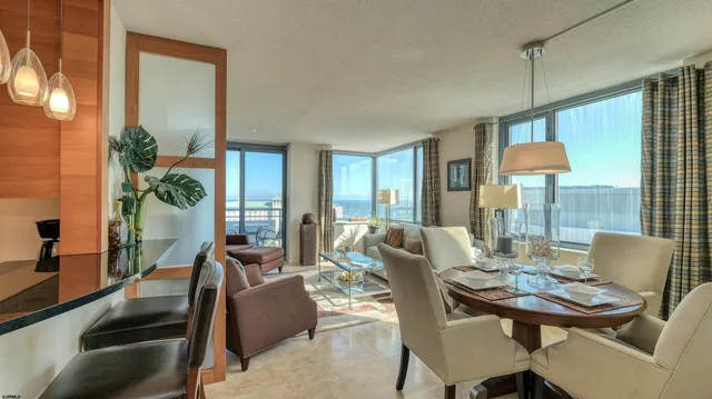 a living room with furniture a wooden floor and a large window