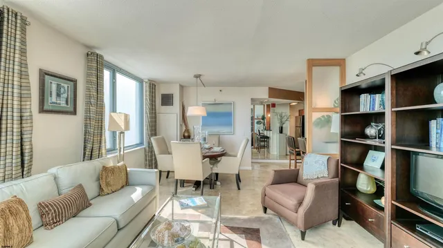a living room with furniture and a book shelf