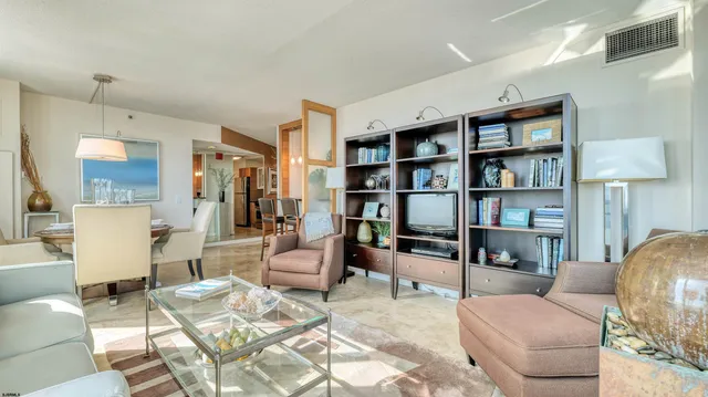 a living room with furniture and a floor to ceiling window