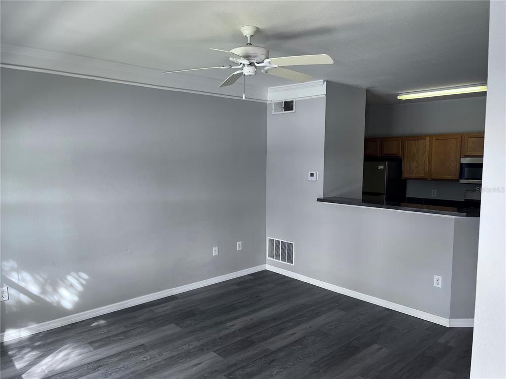 4802 51st Street West, Unit 521 Bradenton, FL 34210 - Photo 3 of 16 a view of a livingroom with wooden floor