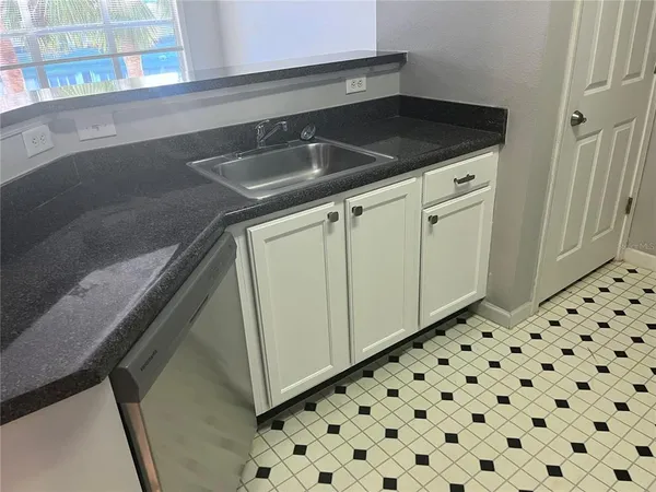a close view of a sink and cabinets