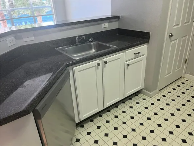 a close view of a sink and cabinets