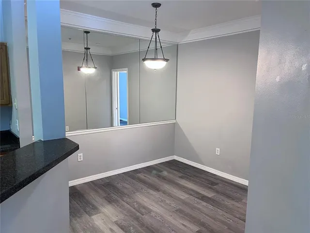 a view of a room with wooden floor and windows
