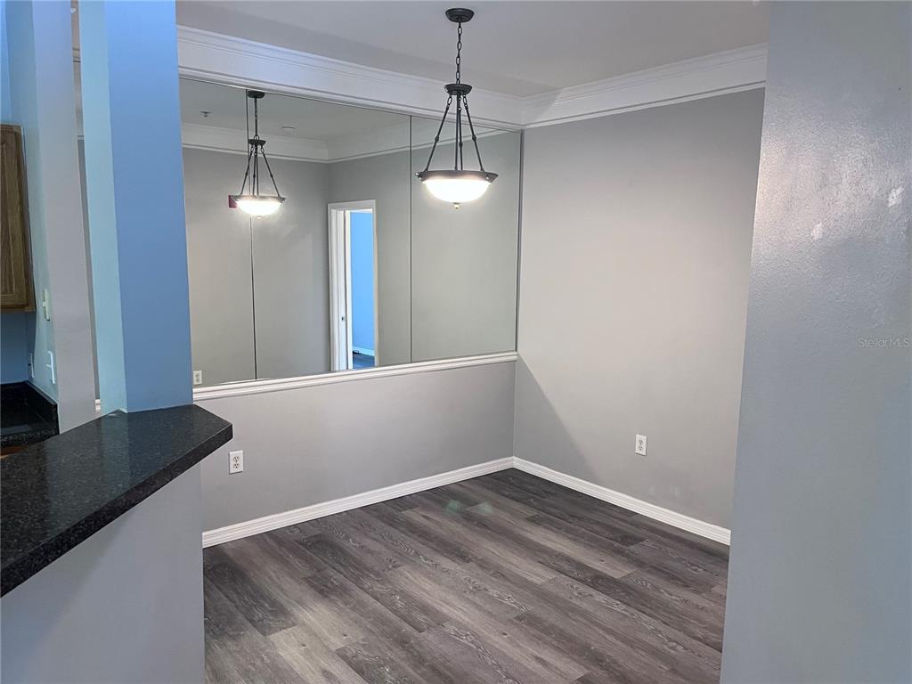 4802 51st Street West, Unit 521 Bradenton, FL 34210 - Photo 7 of 16 a view of a room with wooden floor and windows