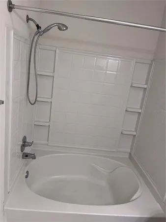 a bathroom with a shower and a bath tub