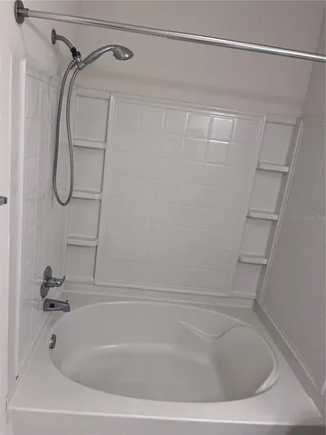 a bathroom with a shower and a bath tub