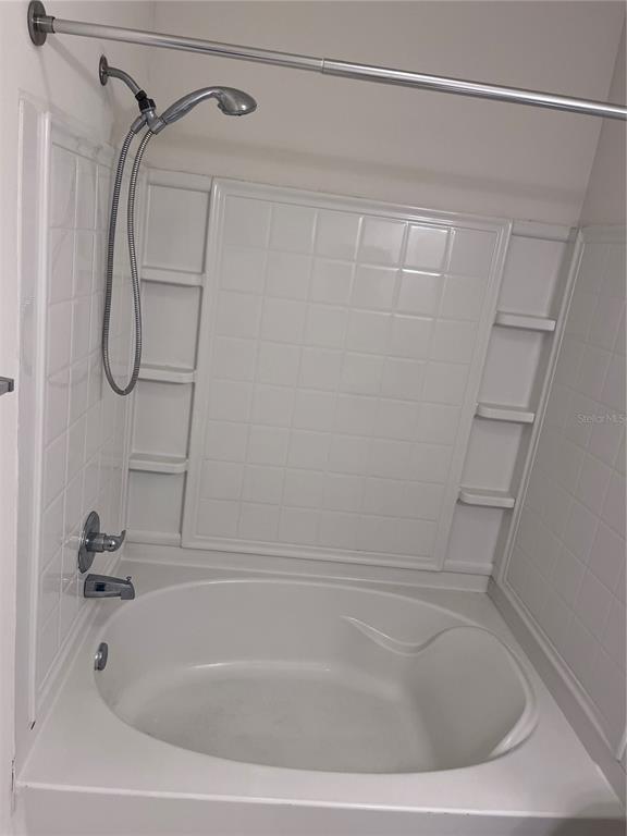 4802 51st Street West, Unit 521 Bradenton, FL 34210 - Photo 9 of 16 a bathroom with a shower and a bath tub